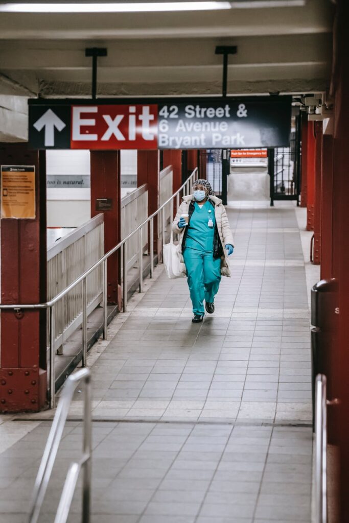 black nurse walking in metro passage